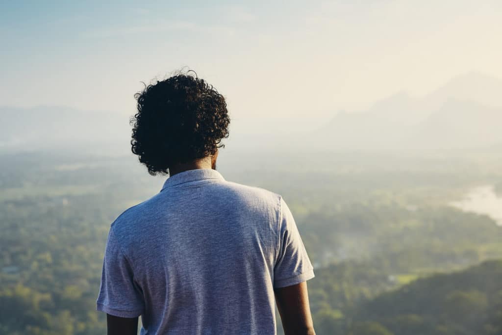 Young man contemplation at the sunset. View from Sigiriya rock in Sri Lanka.